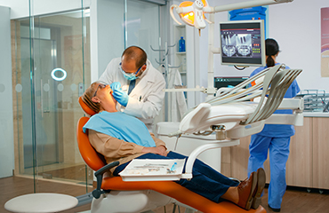 Dentist examining teeth with medical instruments